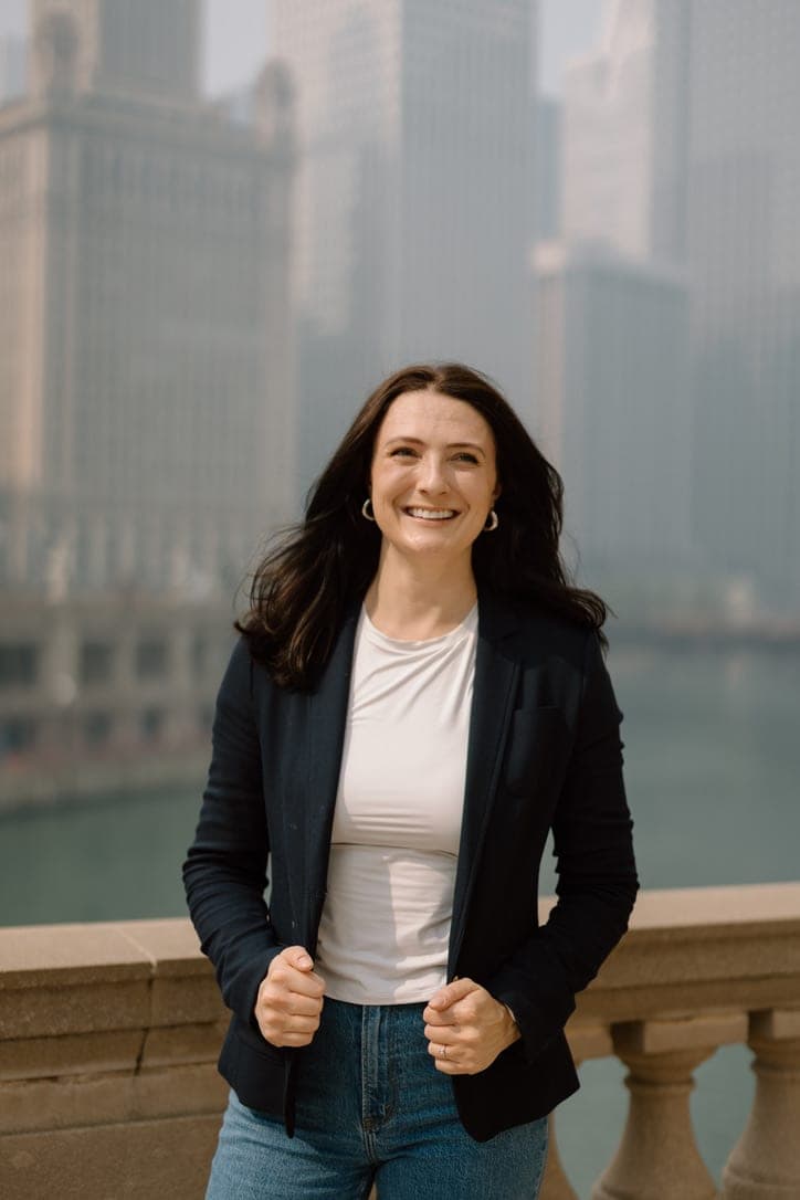 Emily Hyeamang smiling in a navy blazer on the Chicago Riverwalk
